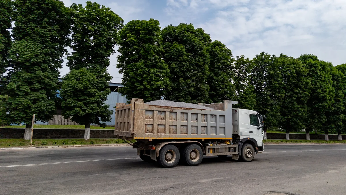 Loaded dump truck on a paved road — Ohio Dump Trucking Insurance from Truck Guard Insurance